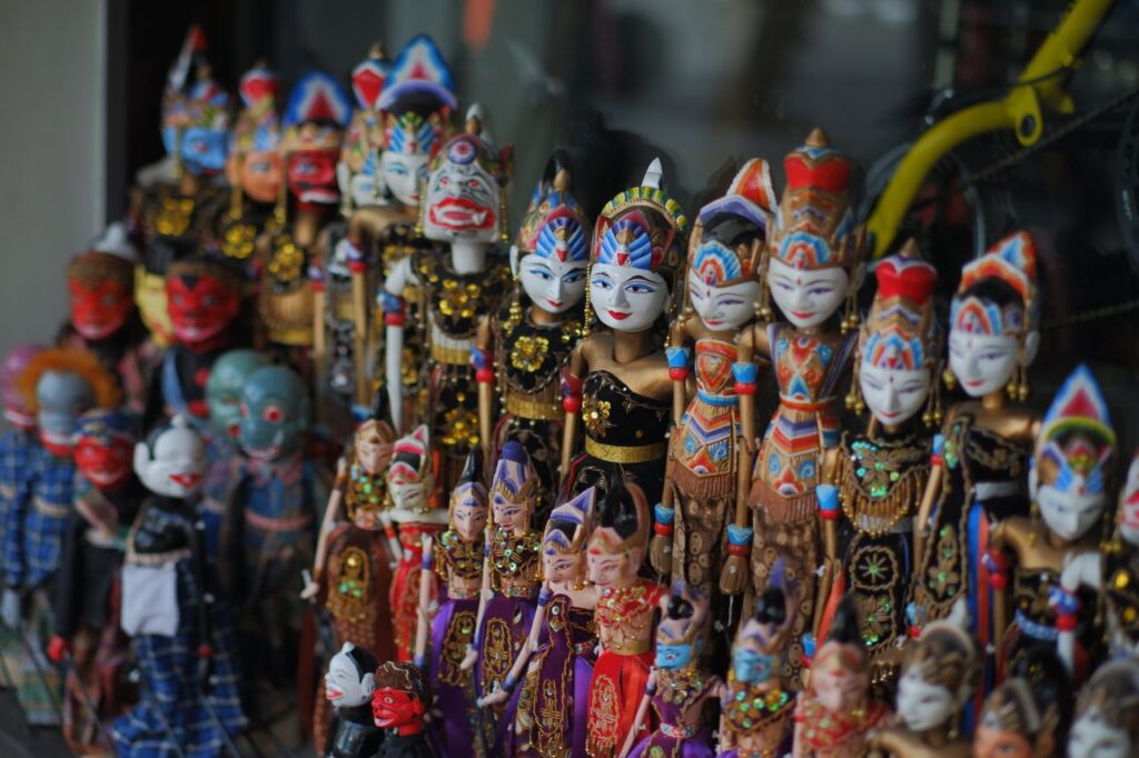 Vibrantly painted Javanese wayang golek puppets on display embodying traditional Indonesian artistry.