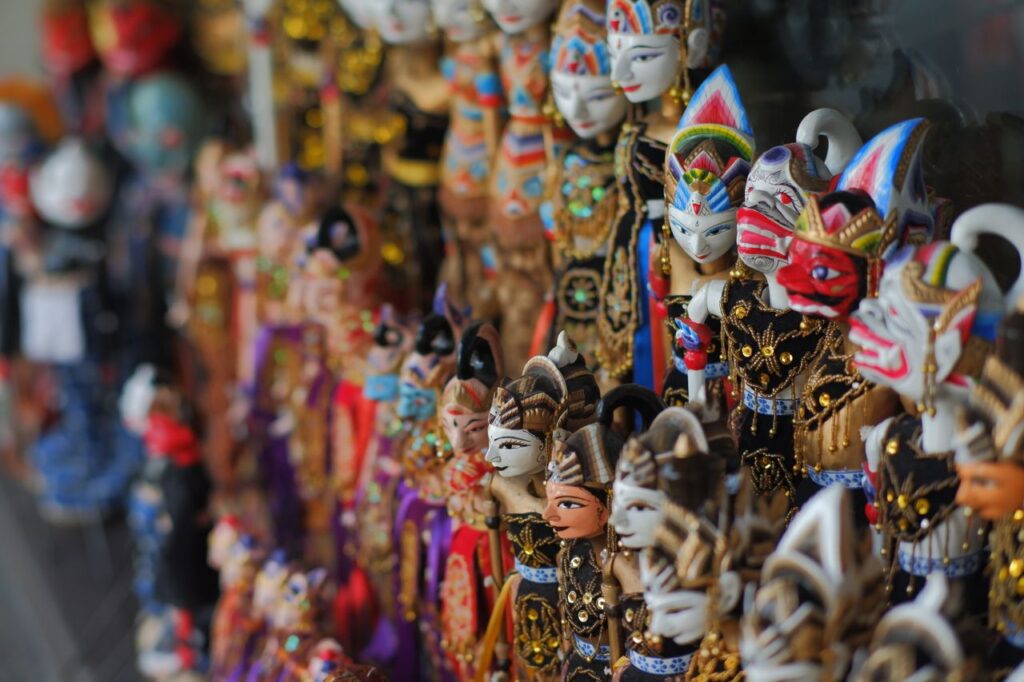 A vibrant display of traditional Javanese Wayang Golek puppets in detailed costumes and masks.